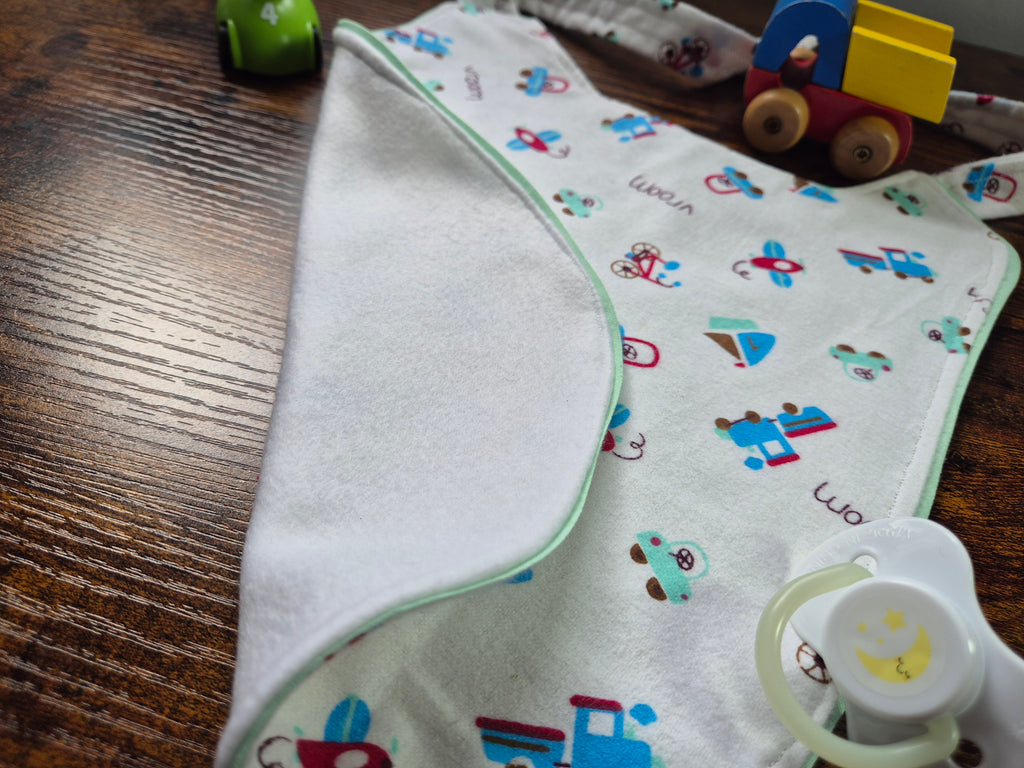 close up of reverse of adult baby bib showing contrast trim and back fabric. 