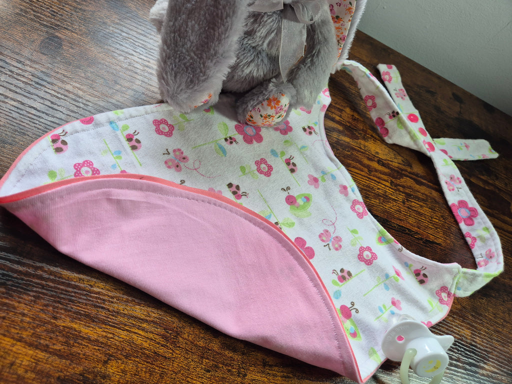 Close of adult baby bib showing contrast trim and reverse fabric. 