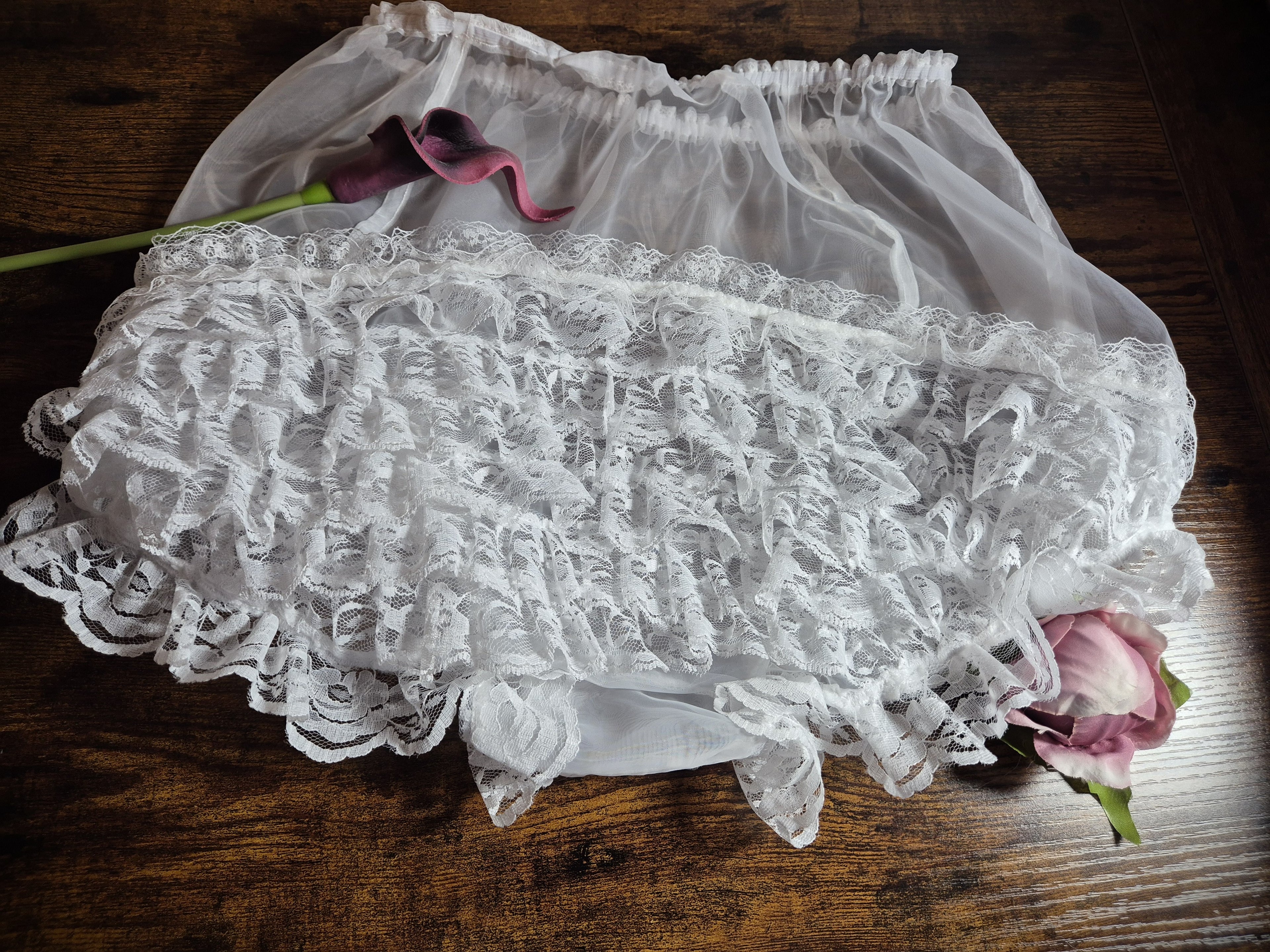 Kitty Nylon Knickers in  white lace displayed on wooden surface with dried floral decoration 