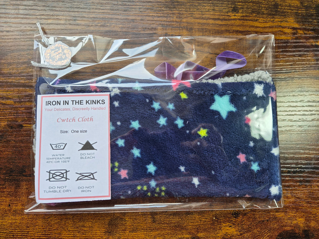 Blue and gray fleece comforter with brightly coloured stars on it