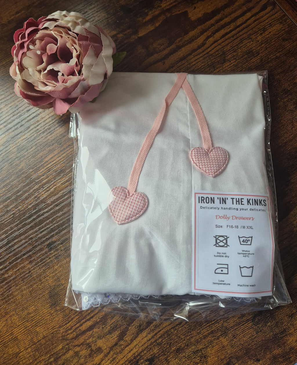 Packaged white pair of dolly drawers showing heart applique detail to drawstring. sissy knickers, adult baby nappy cover, victorian style drawers, unisex