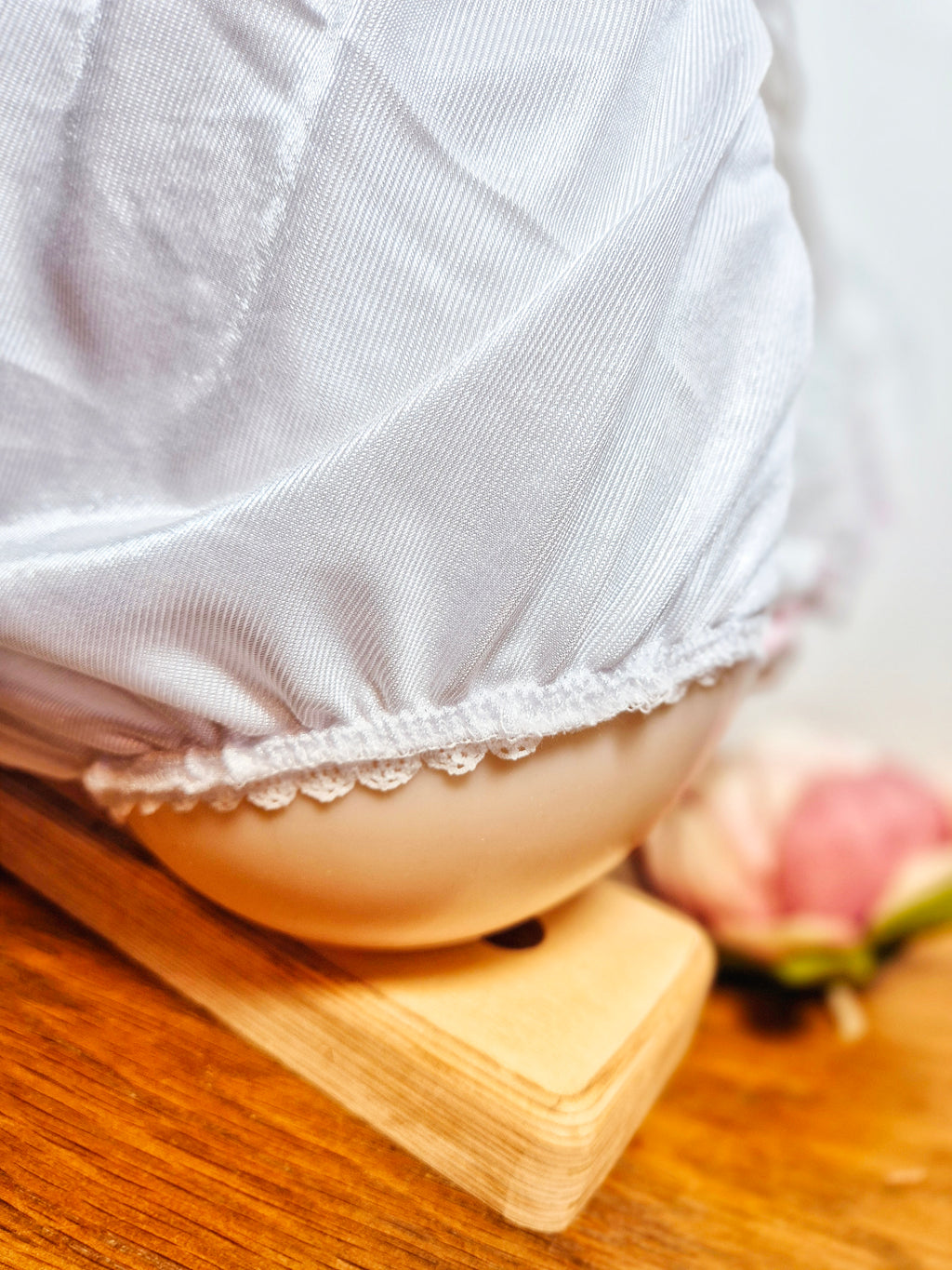 Close-up of Kitty Nylon Knickers leg opening showing white nylon fabric with white elastic trim and pink rose