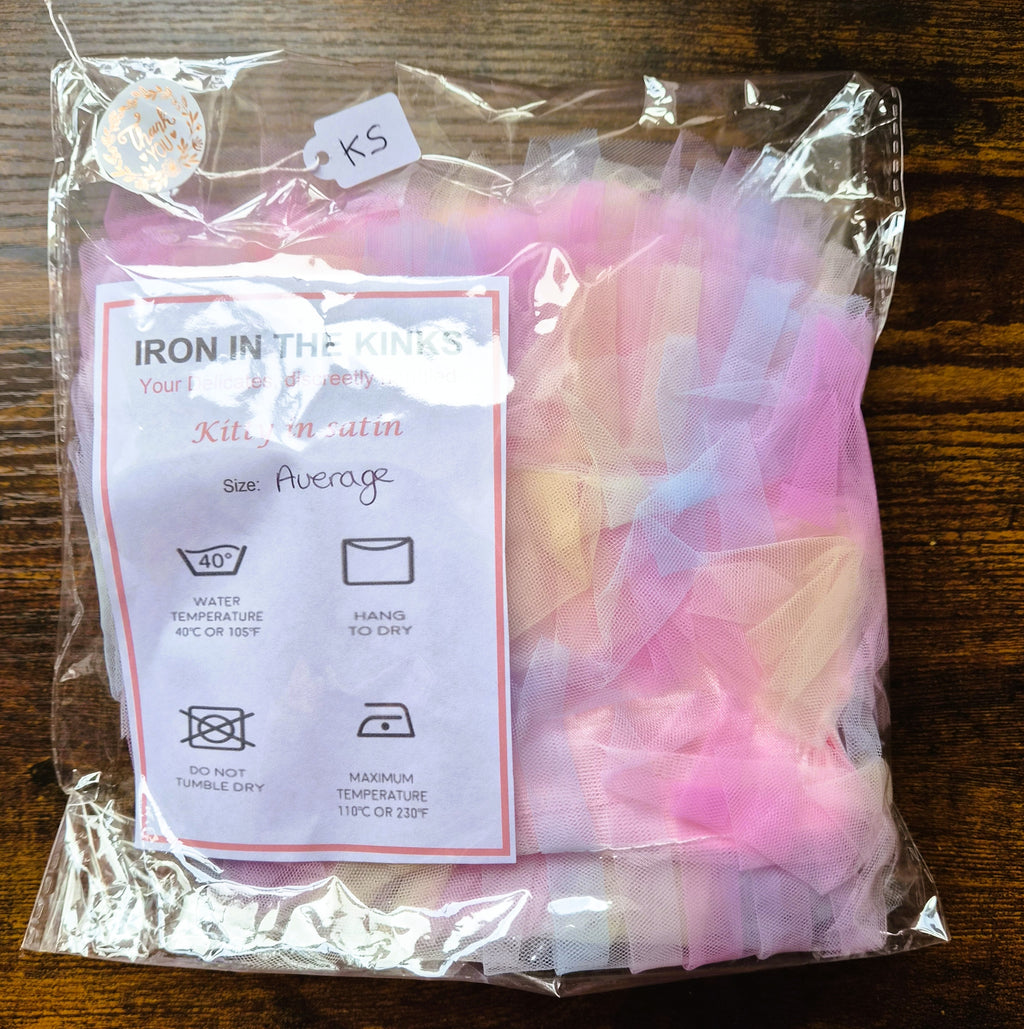 Pink satin panties with ribbon ruffle across the back