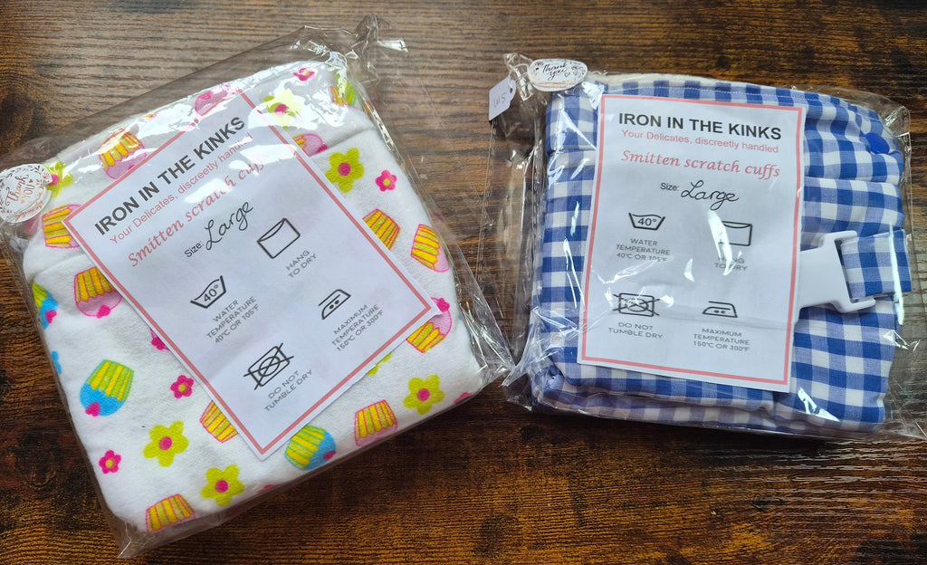 Large size smittens in celophane wrappers. One in cupcake pattern fabric and the other in blue gingham.