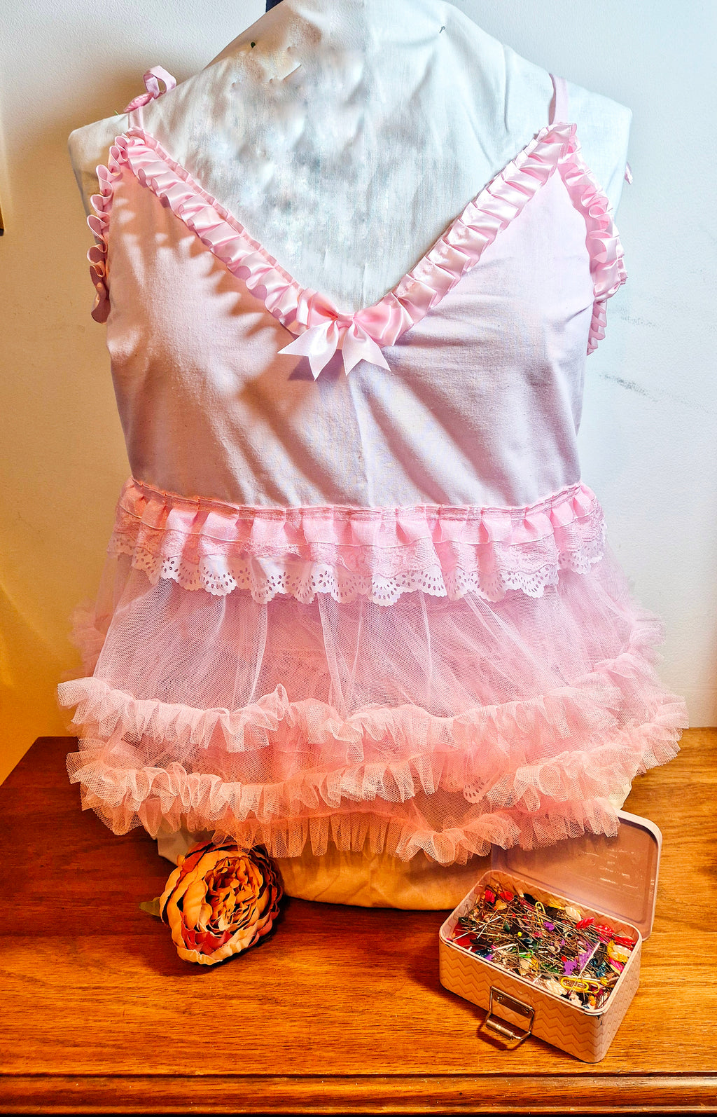 Tilly Vintage Style Cami Top in pink on dress form, three-quarter view showing V-neckline with pink satin ruffle trim and bow detail