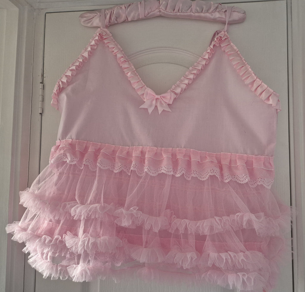 Front view of Tilly Vintage Style Cami Top in white with V-neckline, broderie anglaise trim, pink satin bows and tiered tulle hem
