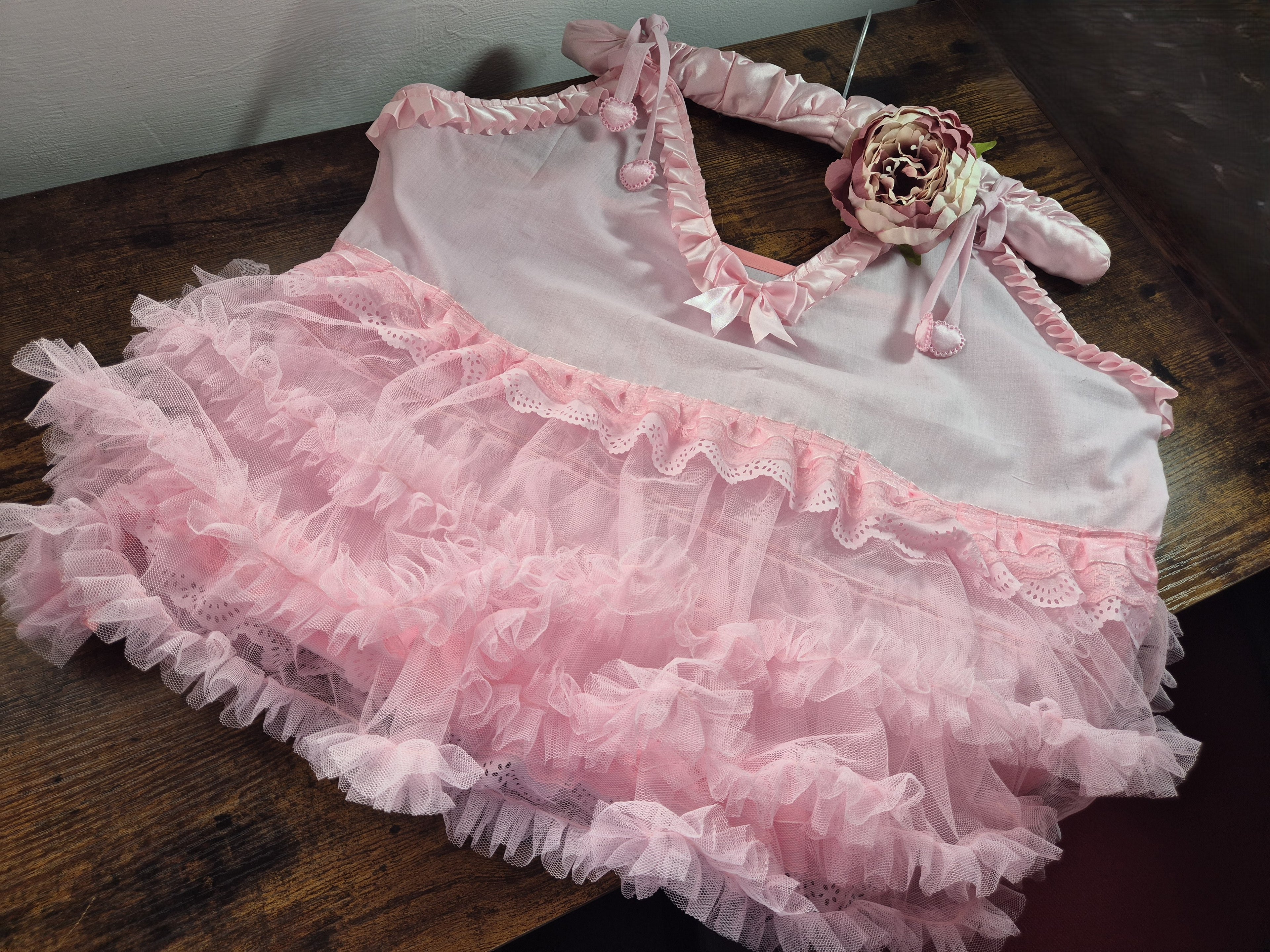 Tilly Vintage Style Cami Top in white laid flat, showing V-neckline with broderie anglaise trim and pink satin ribbon detail