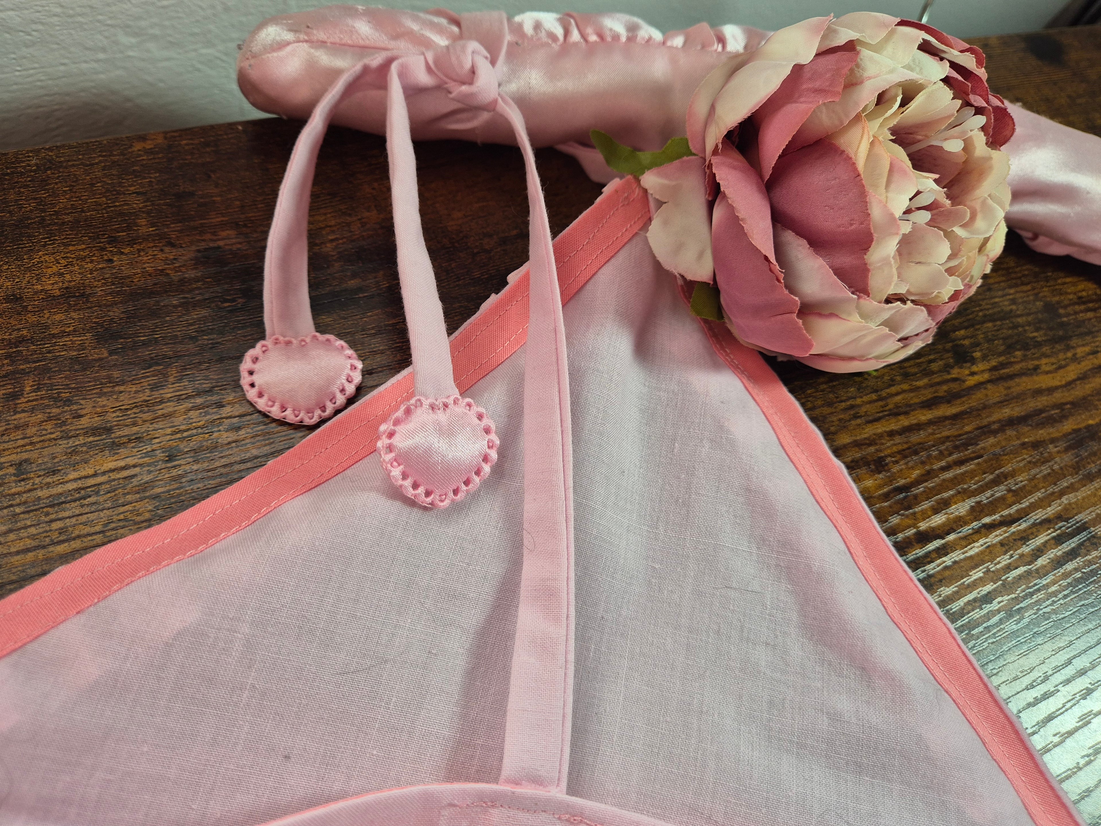 Close-up of Tilly Vintage Style Cami Top tie shoulder strap in pink satin ribbon